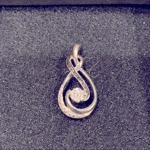 Sterling silver. Infinity-style diamond pendant.